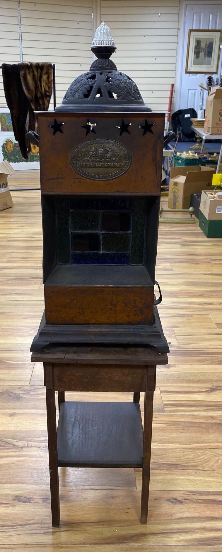 A Rippingilles Patent ABC Stove, Albion Lamp Co., oxidised copper frame, with leaded stained glass panel, circa 1860, 64cm high